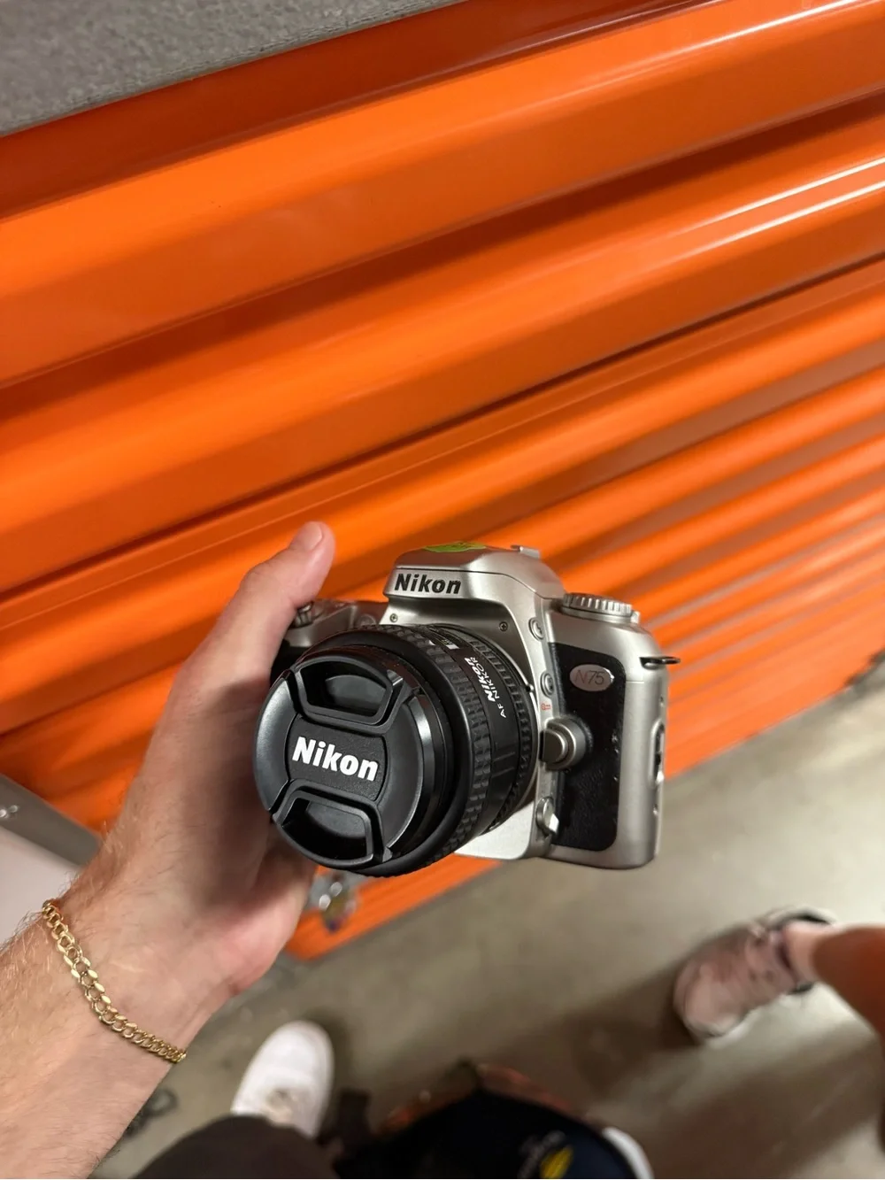 Nikon Silver and Black DSLR Camera with Nikon Lens Cap